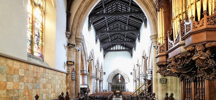 Why do some churches expose wooden beams in the ceiling?